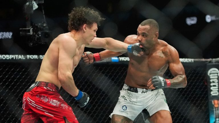 Russia's Roman Kopylov, left, punches Brazil's Cesar Almeida, right, during the third round of a welterweight bout.