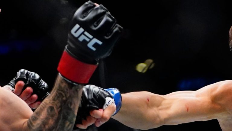 South Korea's Choi Seungwoo, right, punches Michael Trizano during the first round during the UFC 281 mixed martial arts event.