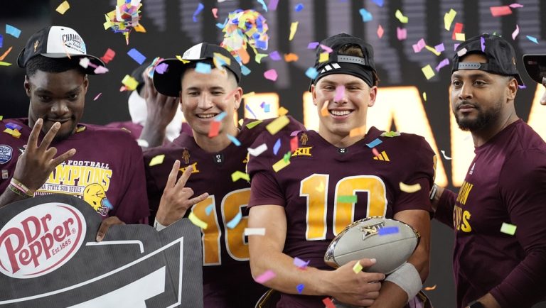 Arizona State quarterback Sam Leavitt (10) celebrates with teammates after the team's win in the Big 12 Conference championship NCAA college football game against Iowa State, in Arlington, Texas, Dec. 7, 2024.