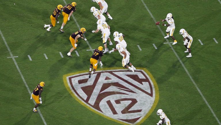 The Pac-12 logo is shown during the second half of an NCAA college football game between Arizona State and Kent State, in Tempe, Ariz., Aug. 29, 2019. Southeastern Conference and Pac-12 officials are expected to provide the final approval of a $2.8 billion plan that will settle antitrust claims and set the stage for college athletes to start sharing the billions of dollars flowing to their schools.