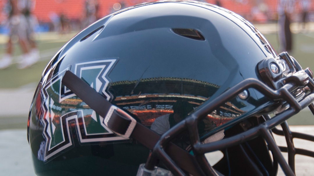 A Hawaii football helmet sits on a case before the start of an NCAA college football game, Saturday, Sept. 19, 2015, in Honolulu. (AP Photo/Eugene Tanner)