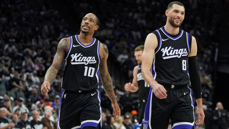 Zach Lavine #8 and DeMar DeRozan #10 of the Sacramento Kings smile between plays against the Phoenix Suns in the second quarter at Golden 1 Center on April 13, 2025 in Sacramento, California.