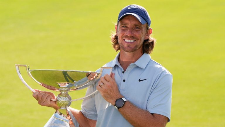 Tommy Fleetwood, of England, holds the championship trophy after the final round of the Tour Championship golf tournament, Sunday, Aug. 24, 2025, in Atlanta.
