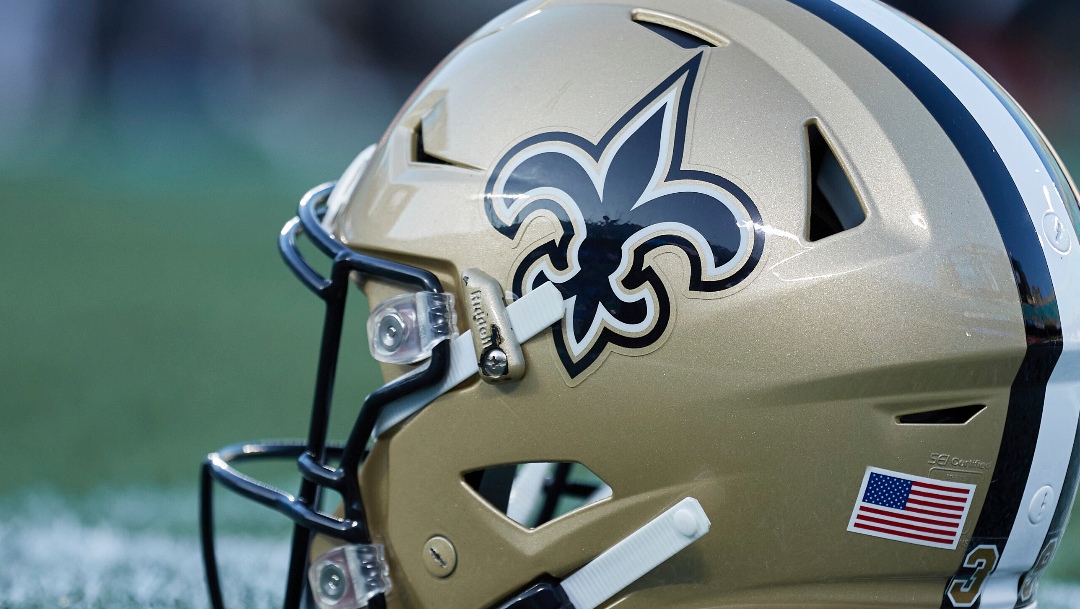 A New Orleans Saints helmet sits on the turf prior to an NFL football game against the Carolina Panthers, Monday, Sep. 18, 2023, in Charlotte, N.C. (AP Photo/Brian Westerholt)