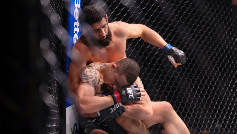 Robert Whittaker, below, is pinned down by Khamzat Chimaev during a middleweight bout at UFC Fight Night on Saturday, Oct. 26.