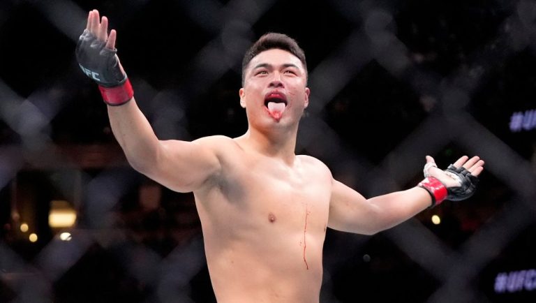 Zhang Mingyang celebrates after defeating Brendson Ribeiro at the UFC 298 mixed martial arts event Saturday, Feb. 17, 2024.