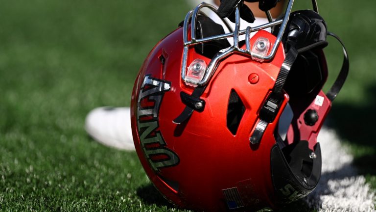 UNLV offensive lineman Leif Fautanu (79) rests his helmet on the turf before the NCAA college football game against Notre Dame, Saturday, Oct. 22, 2022, in South Bend, Ind. (AP Photo/Marc Lebryk)
