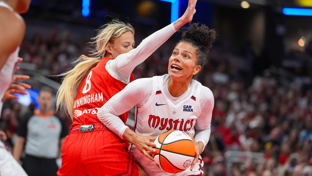 Washington Mystics forward Alysha Clark (32) looks to shoot around Indiana Fever guard Sophie Cunningham (8) in the second half of a WNBA basketball game in Indianapolis, Friday, Aug. 15, 2025.