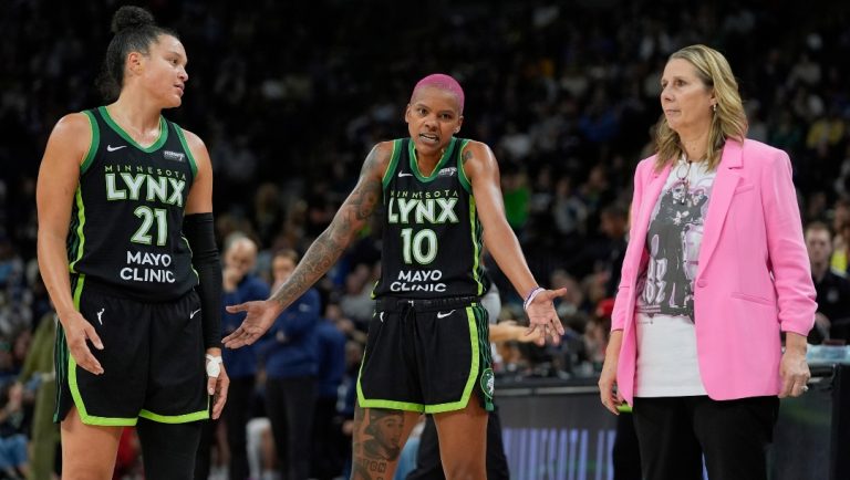 Minnesota Lynx guards Kayla McBride (21) Courtney Williams (10) and head coach Cheryl Reeve talk during the second half of a WNBA basketball game against the Indiana Fever Sunday, Aug. 24, 2025, in Minneapolis.