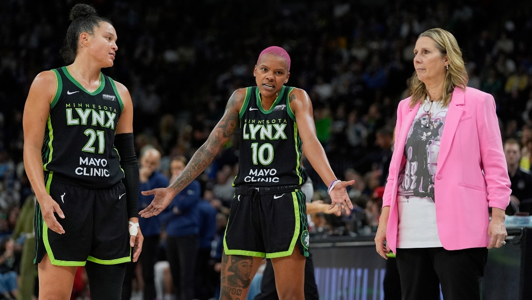 Minnesota Lynx guards Kayla McBride (21) Courtney Williams (10) and head coach Cheryl Reeve talk during the second half of a WNBA basketball game against the Indiana Fever Sunday, Aug. 24, 2025, in Minneapolis.