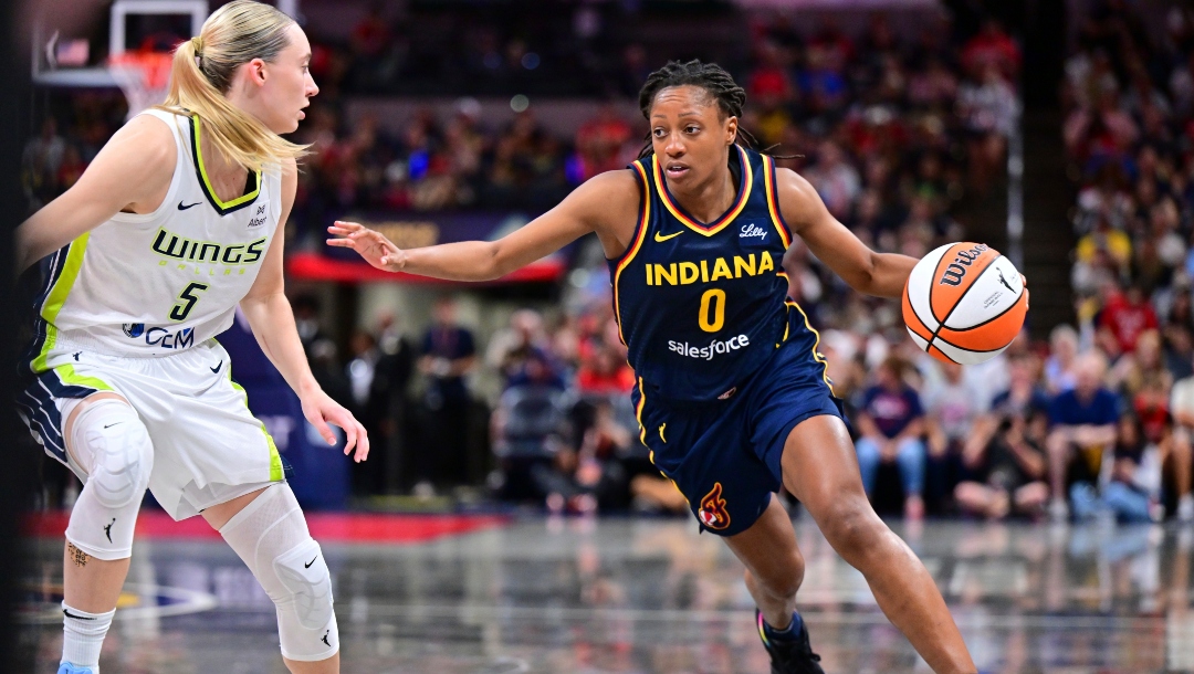Indiana Fever's Kelsey Mitchell (0) goes to the basket against Dallas Wings' Paige Bueckers (5) during the second half of a WNBA basketball game, Sunday, July 13, 2025, in Indianapolis.