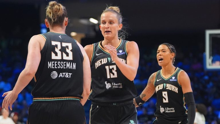 New York Liberty forward Leonie Fiebich (13) celebrates after a score with teammate center Emma Meesseman (33) and guard Natasha Cloud (9) during the first half of a WNBA basketball game against the Dallas Wings in Arlington, Texas, Friday, Aug. 8, 2025.