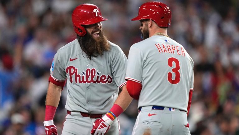 Philadelphia Phillies' Brandon Marsh, left, is congratulated by Bryce Harper after hitting a three-run home run during the sixth inning of a baseball game against the Los Angeles Dodgers, Tuesday, Sept. 16, 2025, in Los Angeles.