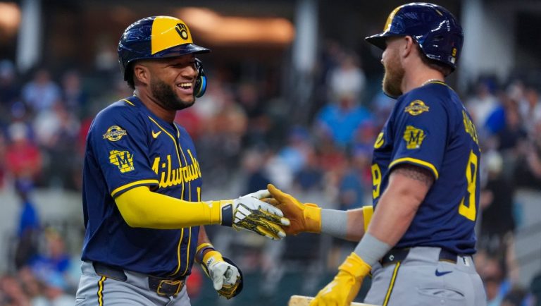 Milwaukee Brewers' Jackson Chourio, left, is greeted near the on deck circle by Jake Bauers after hitting a solo home run off Texas Rangers starting pitcher Merrill Kelly during the first inning of a baseball game Wednesday, Sept. 10, 2025, in Arlington, Texas.