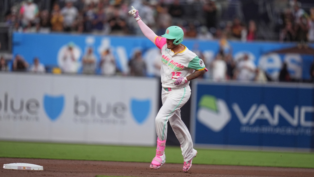 San Diego Padres' Manny Machado celebrates after hitting a home run during the first inning of a baseball game against the Colorado Rockies Friday, Sept. 12, 2025, in San Diego.