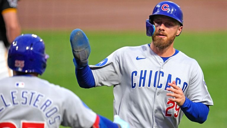 Chicago Cubs' Michael Busch (29) is greeted by Moisés Ballesteros as he returns to the dugout after scoring on a sacrifice fly by Ian Happ off Pittsburgh Pirates pitcher Paul Skenes during the second inning of a baseball game in Pittsburgh, Tuesday, Sept. 16, 2025.
