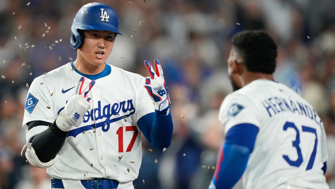 Los Angeles Dodgers' Shohei Ohtani celebrates with Teoscar Hernández (37) after his two-run home run during the sixth inning in Game 1 of the National League Wild Card baseball playoff series against the Cincinnati Reds, Tuesday, Sept. 30, 2025, in Los Angeles.