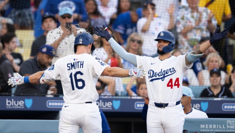 Los Angeles Dodgers' Will Smith, left, is showered with sunflower seeds by Andy Pages after hitting a solo home run during the second inning of a baseball game against the Houston Astros in Los Angeles, Friday, July 4, 2025.