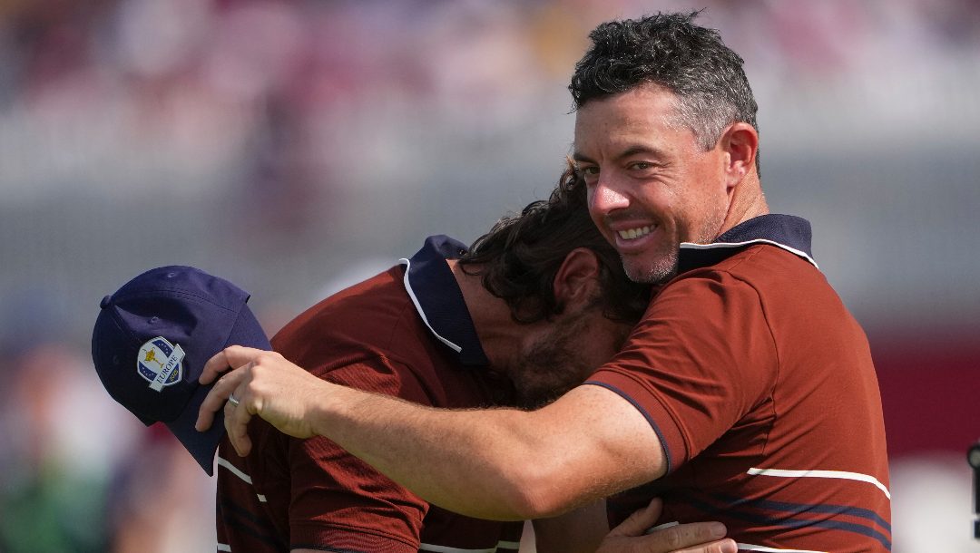 Europe's Rory McIlroy and Tommy Fleetwood hug after they won their match at Bethpage Black golf course during the Ryder Cup golf tournament, Saturday, Sept. 27, 2025, in Farmingdale, N.Y.