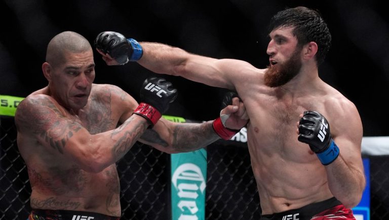 Alex Pereira, left, fights Magomed Ankalaev during a UFC 313 mixed martial arts light heavyweight title bout Saturday, March 8.
