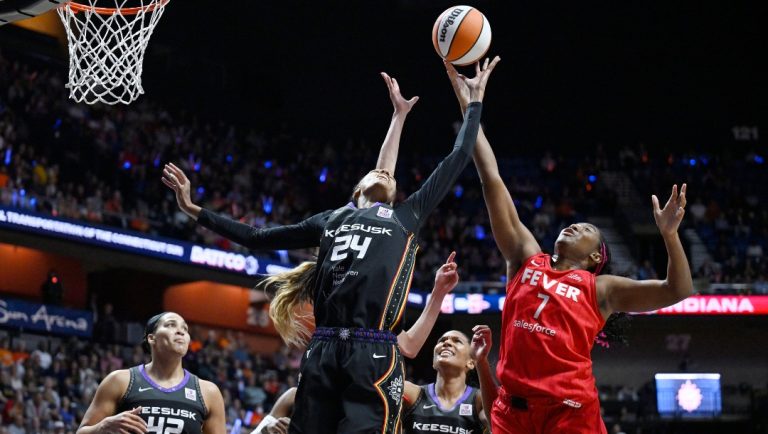 Connecticut Sun forward DeWanna Bonner (24) and Indiana Fever forward Aliyah Boston (7) reach for a rebound during the first half in Game 2 of a first-round WNBA basketball playoff series, Wednesday, Sept. 25, 2024, in Uncasville, Conn.