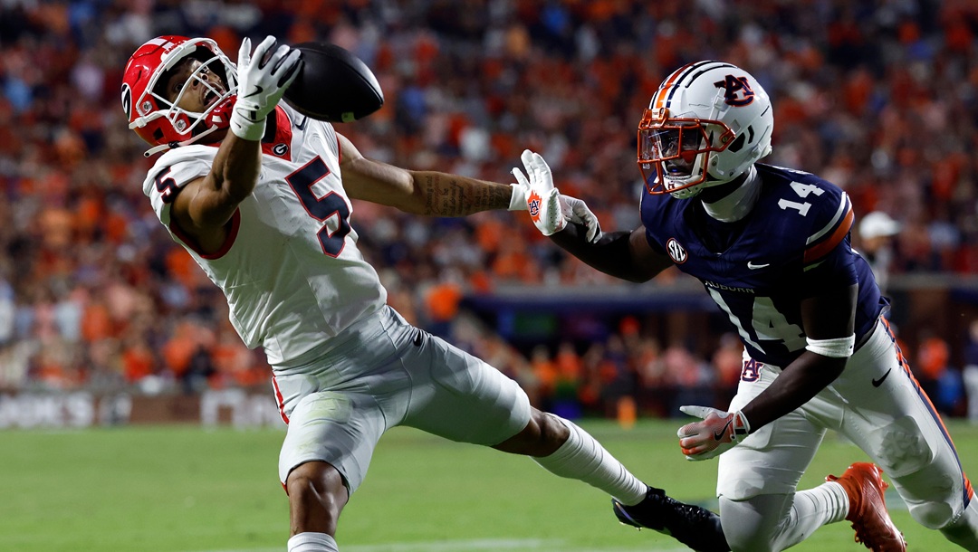Georgia wide receiver Noah Thomas (5) tries to catch a pass as Auburn defensive back Rayshawn Pleasant (14) defends during the second half of an NCAA college football game, Saturday, Oct. 11, 2025, in Auburn, Ala.