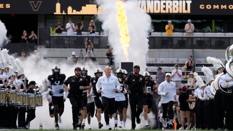 Vanderbilt head coach Clark Lea, center, leads his team onto the field before an NCAA college football game Saturday, Sept. 27, 2025, in Nashville, Tenn.