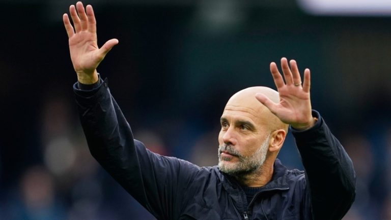Manchester City's head coach Pep Guardiola waves to the fans after the Premier League soccer match between Manchester City and Everton in Manchester, England, Saturday, Oct. 18, 2025.