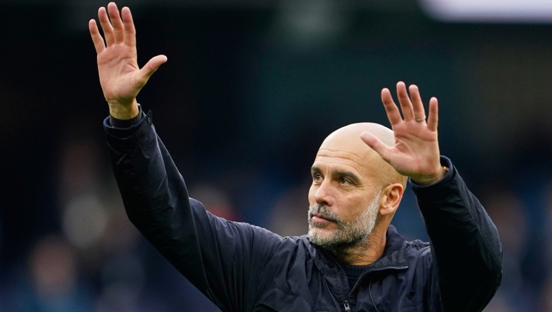 Manchester City's head coach Pep Guardiola waves to the fans after the Premier League soccer match between Manchester City and Everton in Manchester, England, Saturday, Oct. 18, 2025.