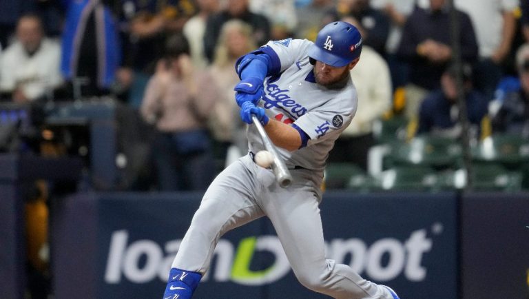 Los Angeles Dodgers' Max Muncy hits a home run against the Milwaukee Brewers during the sixth inning in Game 2 of baseball's National League Championship Series, Tuesday, Oct. 14, 2025, in Milwaukee.