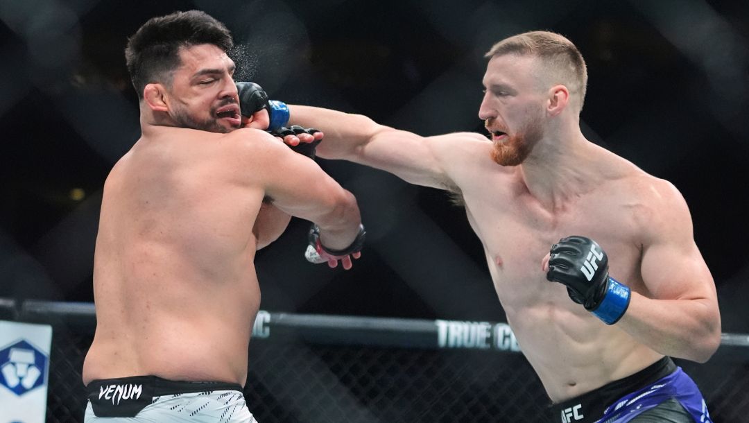 Joe Pyfer, right, punches Kelvin Gastelum during the first round of a middleweight bout at the UFC 316 mixed martial arts event.