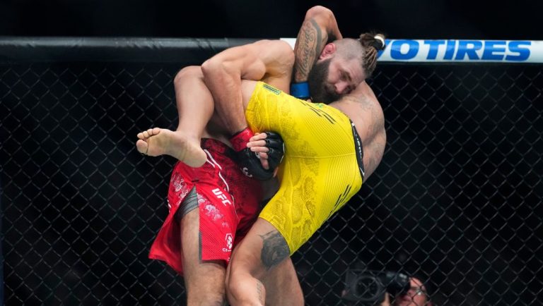 Czech Republic's Jirí Procházka works against Brazil's Alex Pereira, right, during the first round of a light heavyweight.