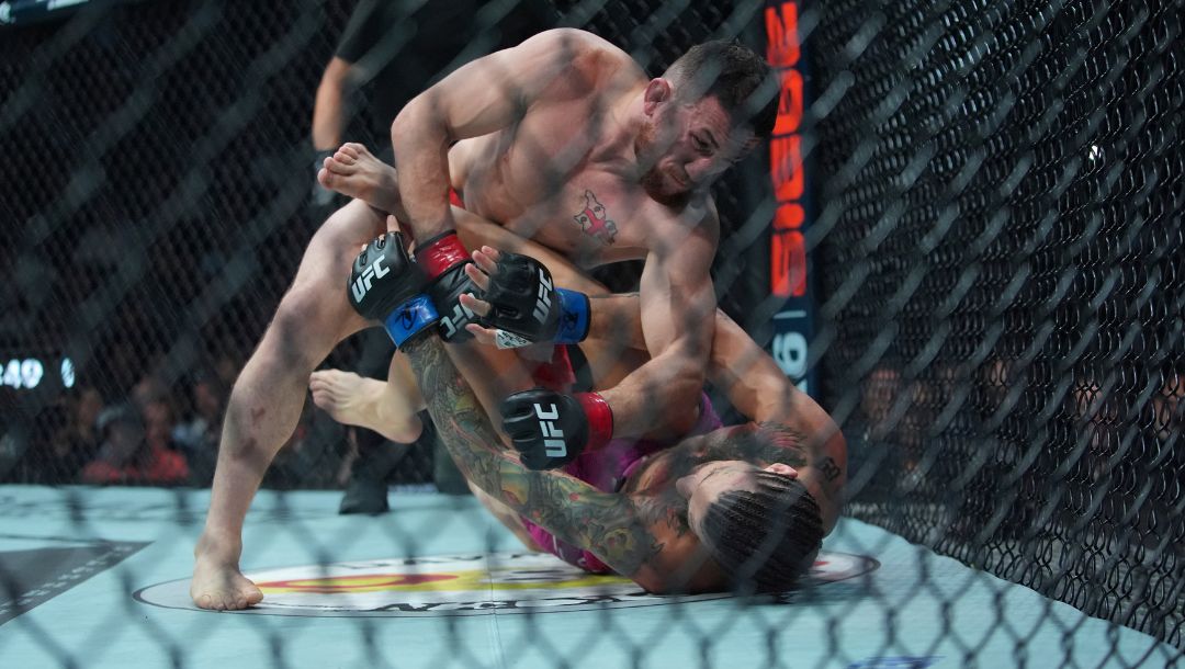 Georgia's Merab Dvalishvili, left, punches Sean O'Malley during the first round of a bantamweight title bout.
