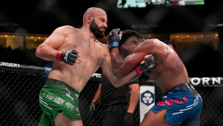 Russia's Azamat Murzakanov, left, punches Alonzo Menifield, right, of the United States, at a UFC Fight Night.