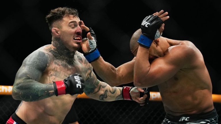 England's Tom Aspinall, left, fight Ciryl Gane, of France, during the heavyweight title bout at the UFC mixed martial arts.