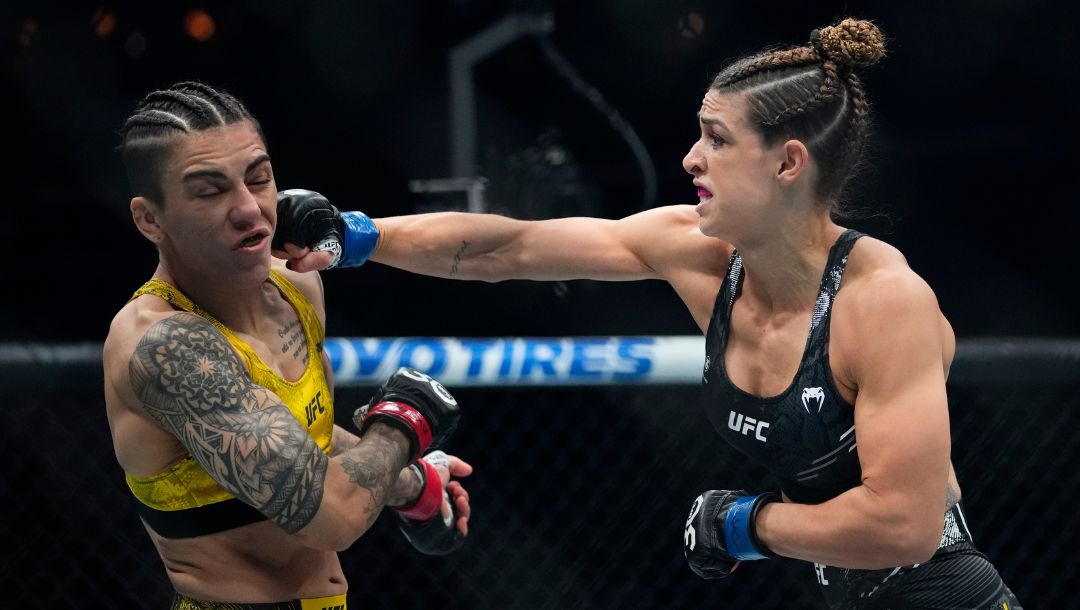 Brazil's Mackenzie Dern, right, punches Brazil's Jessica Andrade during the first round of a women's strawweight bout.