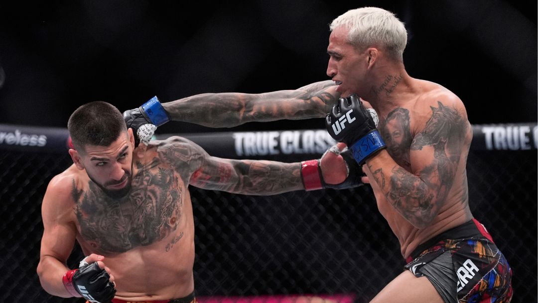 Ilia Topuria, left, fights Charles Oliveira in a lightweight title fight at UFC 317, Saturday, June 28, 2025, in Las Vegas.
