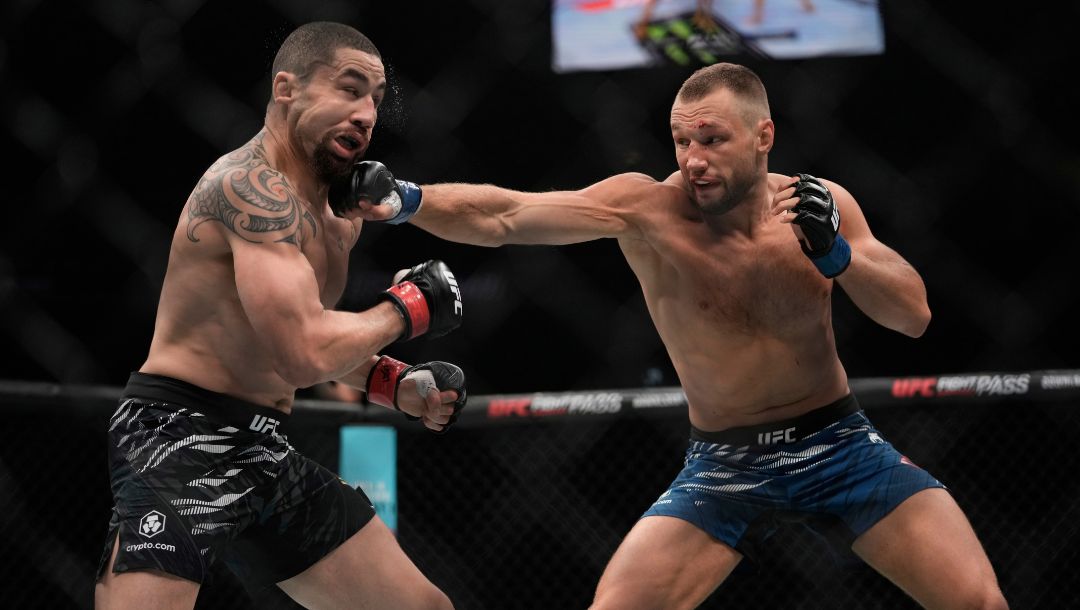 Australia's Robert Whittaker, left, and Reinier de Ridder of the Netherlands fight during a UFC middleweight bout.