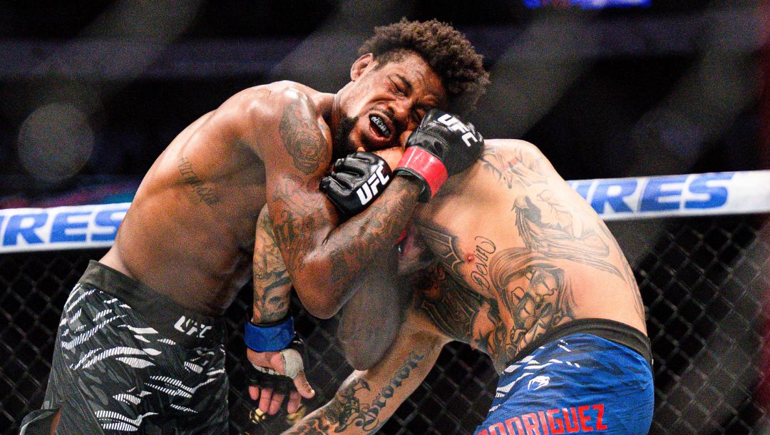 Kevin Holland left, hits Daniel Rodriguez in a welterweight title fight at UFC 318 in New Orleans, La., Saturday, July 19, 2025.