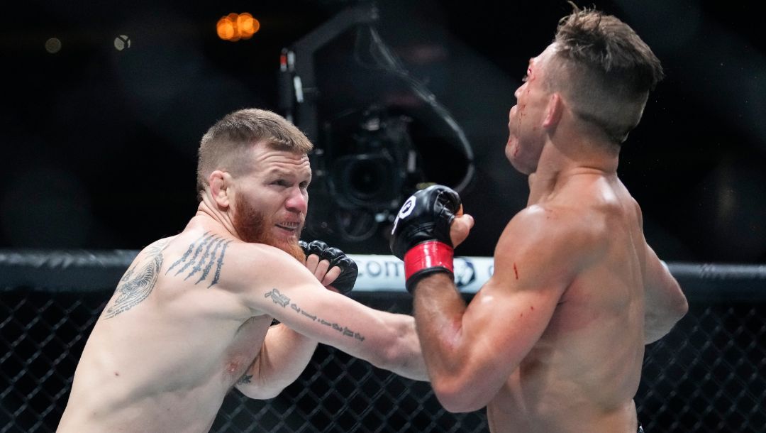 Matt Frevola, left, punches Drew Dober during the first round of a lightweight bout at the UFC 288 mixed martial arts event.