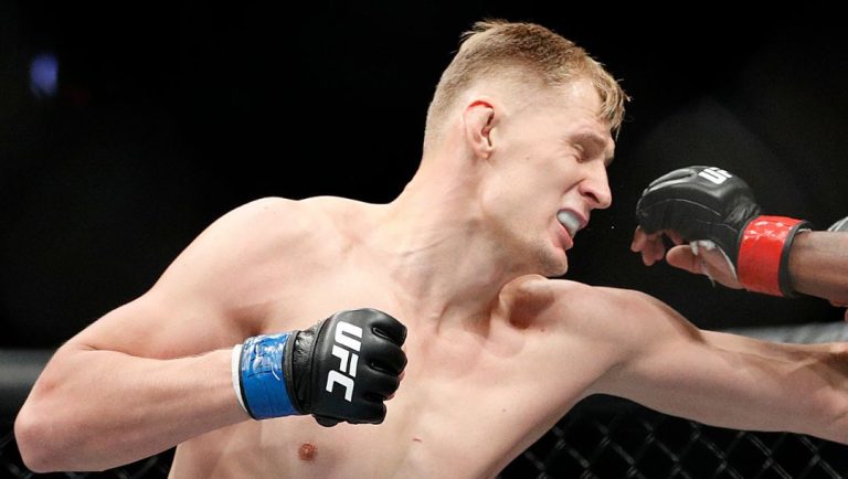 Alexander Volkov, left, punches Derrick Lewis during a heavyweight mixed martial arts bout at UFC 229 in Las Vegas.