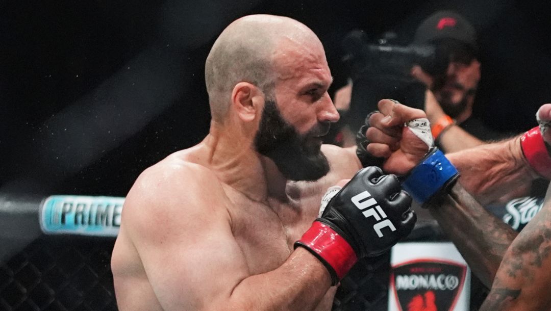 Russia's Azamat Murzakanov, left, punches Brazil's Brendson Ribeiro during the first round of a light heavyweight bout.