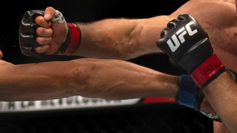 Myktybek Orolbai, left, punches Mateusz Rebecki in a catchweight mixed martial arts bout at UFC Fight Night, Saturday.
