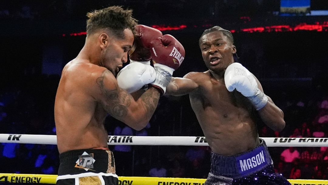 Abdullah Mason, right, punches Puerto Rico's Luis Lebron, left, during the first round of a lightweight boxing match.