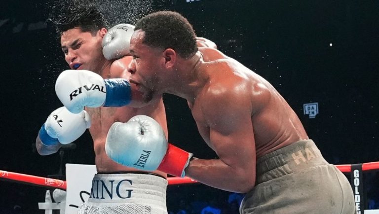Devin Haney, right, punches Ryan Garcia during the 12th round of a super lightweight boxing match early Sunday, April 21, 2024.