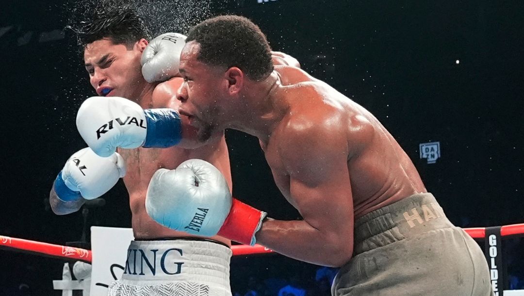 Devin Haney, right, punches Ryan Garcia during the 12th round of a super lightweight boxing match early Sunday, April 21, 2024.