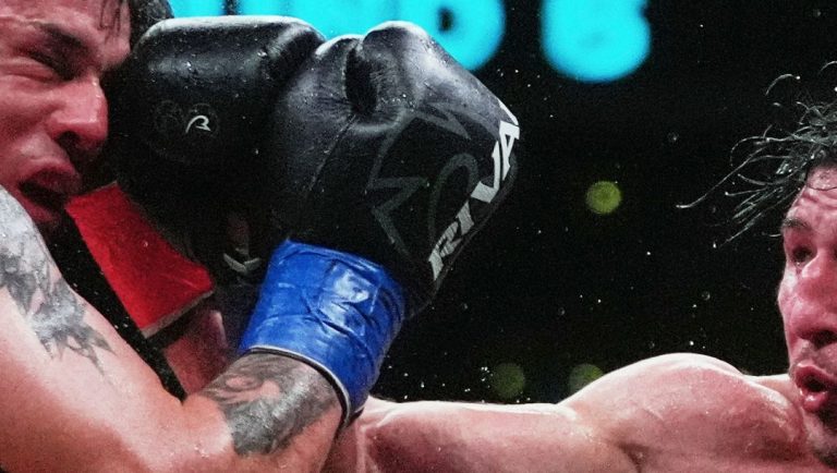 Chris Colbert, right, punches Argentina's Victoriano Antonio Santillan during the sixth round of a junior welterweight boxing.