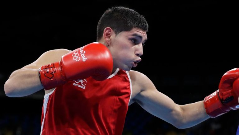 Argentina's Fernando Daniel Martinez, left, fights Bulgaria's Daniel Asenov during a men's flyweight 52-kg preliminary boxing.