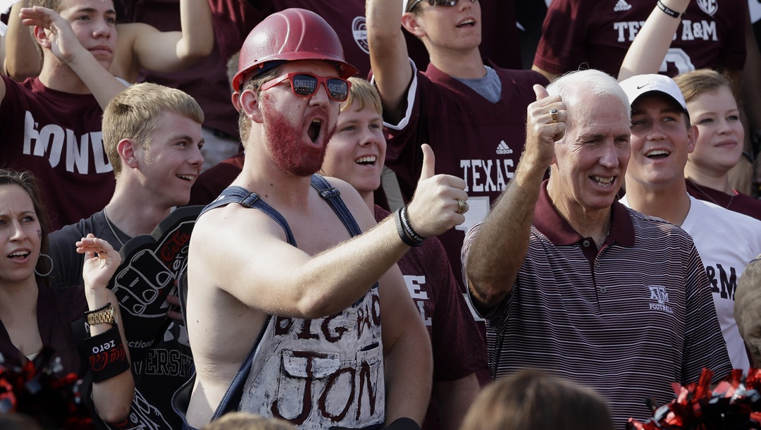 R.C. Slocum, right, former Texas A&M football coach, right, joins fans as they cheer on the set of EPSN's College Gameday before an NCAA college football game between Alabama and Texas A&M Saturday, Sept. 14, 2013, in College Station, Texas.