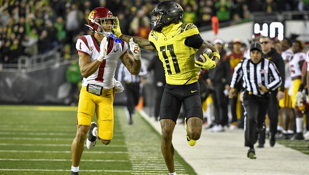 Oregon wide receiver Troy Franklin (11) fights off Southern California cornerback Domani Jackson (1) during the first half of an NCAA college football game Saturday, Nov. 11, 2023, in Eugene, Ore.